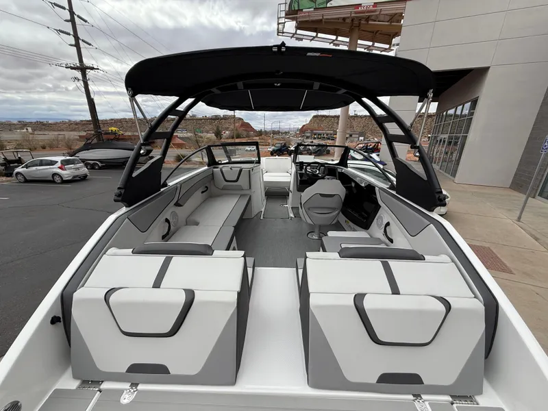 Slide: The Image of 2025 Yamaha Boats AR220 with sleek interior and modern design, docked outdoors. - 26