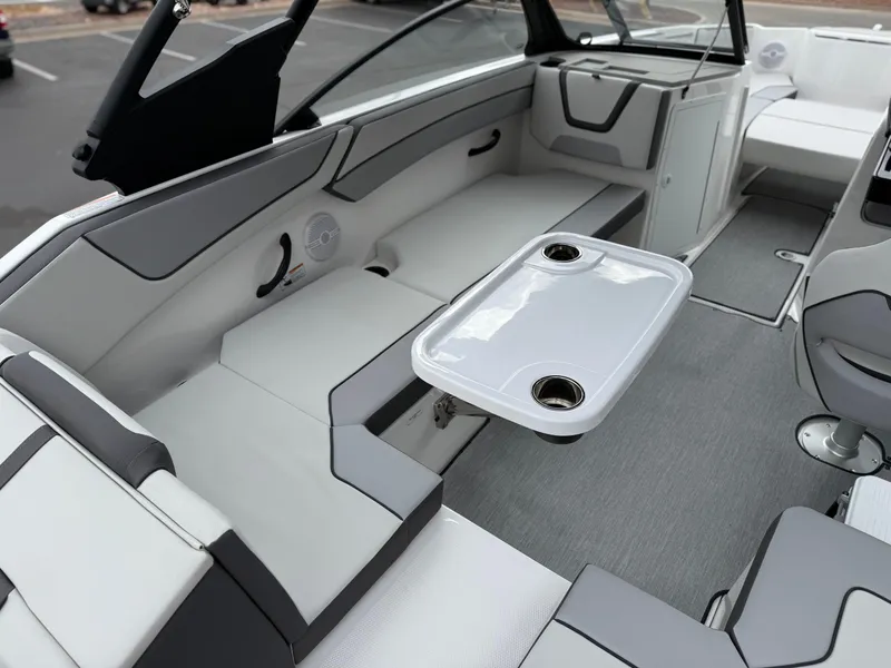 Slide: The Image of 2025 Yamaha Boats AR220 interior with sleek seating and table setup. - 31