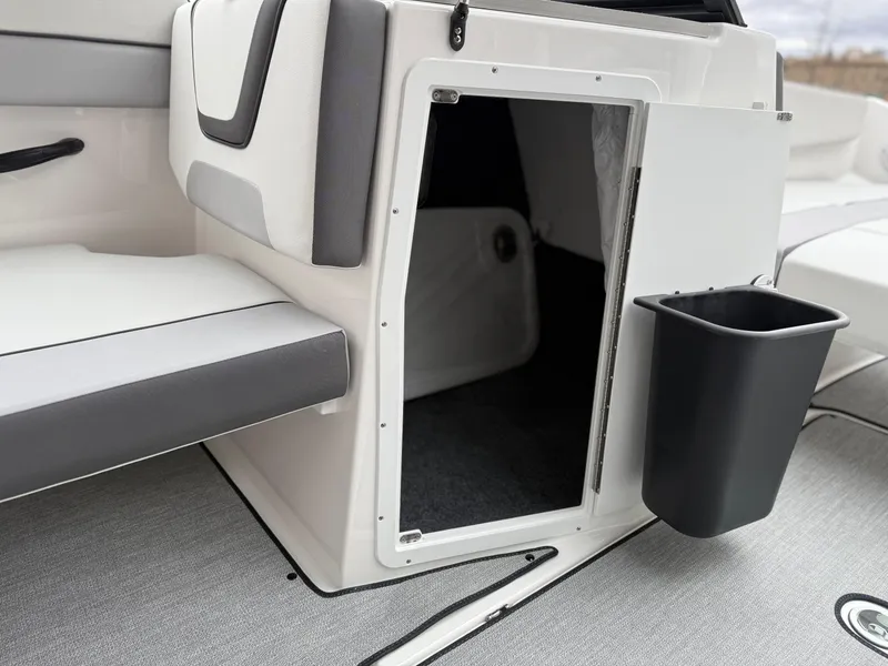 Slide: The Image of Interior storage compartment of 2025 Yamaha Boats AR220 with seating and trash bin. - 39