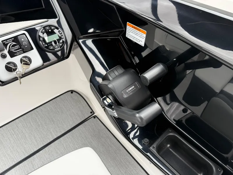Slide: The Image of 2025 Yamaha Boats AR220 control panel with throttle and key ignition. - 44