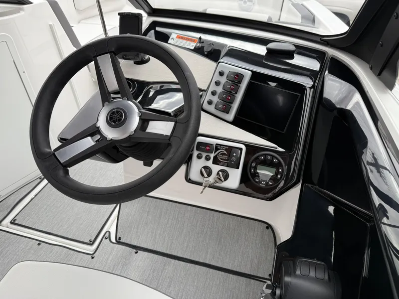 Slide: The Image of 2025 Yamaha Boats AR220 dashboard with steering wheel and control panel. - 45
