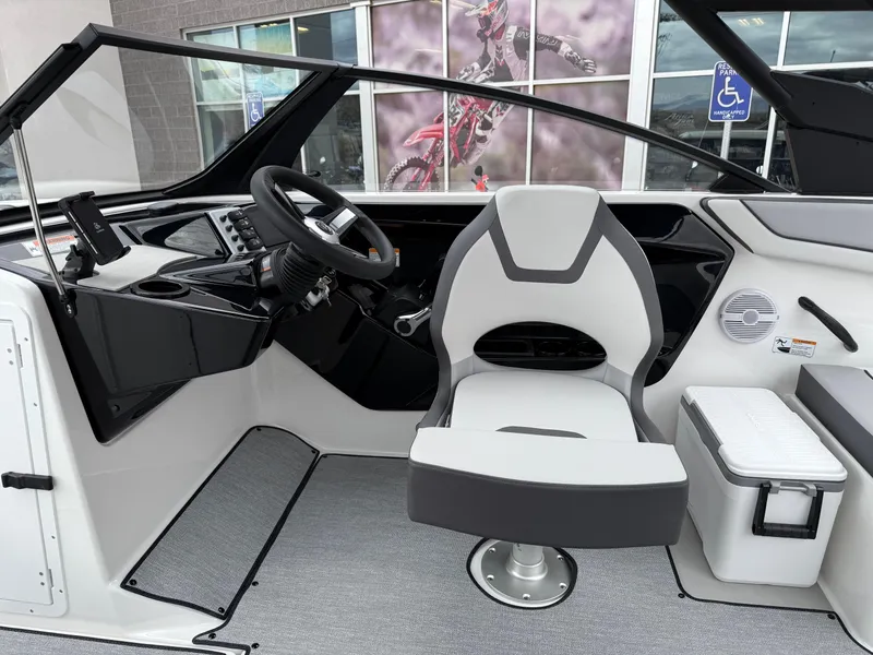 Slide: The Image of 2025 Yamaha Boats AR220 interior with captain's chair and modern dashboard design. - 49