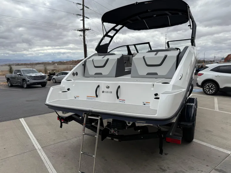 Slide: The Image of 2025 Yamaha Boats AR220 on trailer, rear view with swim platform and ladder. - 6