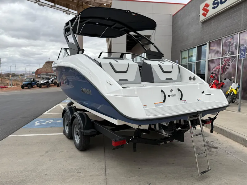 Slide: The Image of 2025 Yamaha Boats AR220 with sleek design, parked outdoors, featuring a modern black canopy. - 8