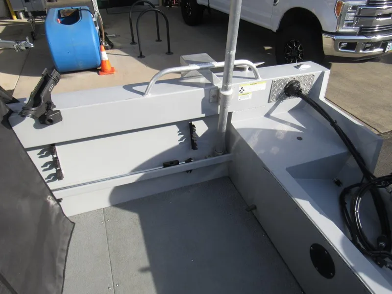 Slide: The Image of 2015 Hewescraft 180 Sportsman boat interior with rod holders and storage compartments. - 10