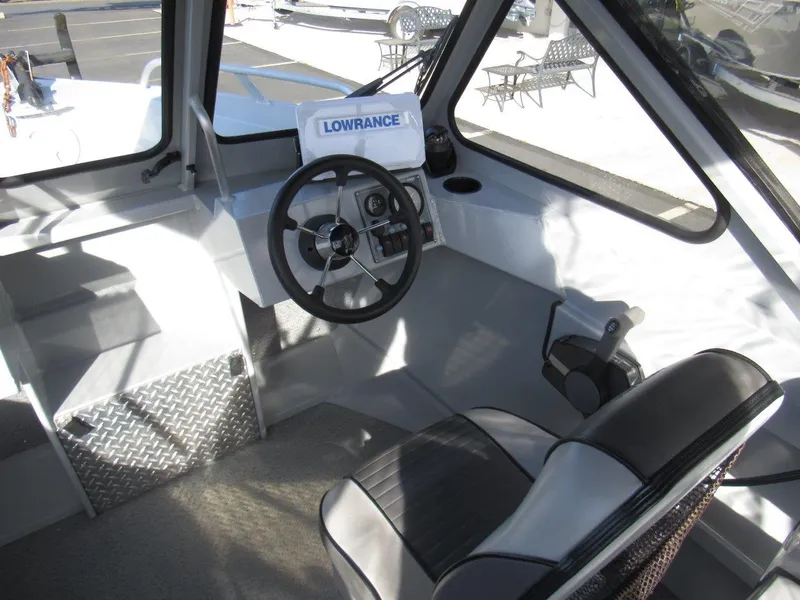 Slide: The Image of 2015 Hewescraft 180 Sportsman boat interior with steering wheel and Lowrance equipment. - 12