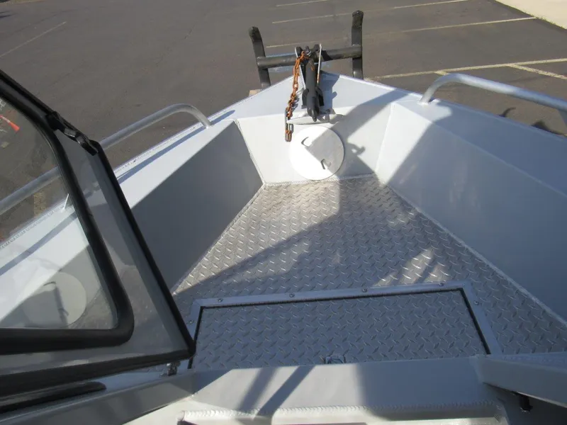Slide: The Image of 2015 Hewescraft 180 Sportsman boat deck with diamond plate flooring and anchor. - 16