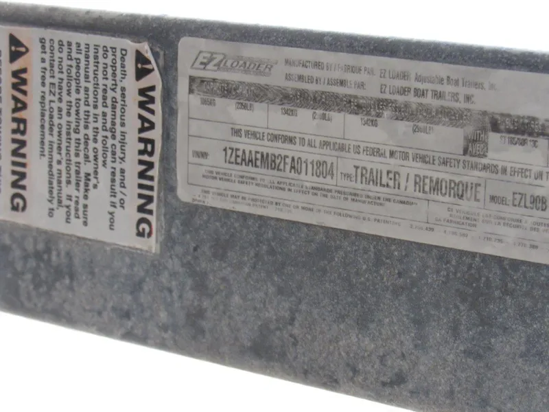 Slide: The Image of Warning labels and VIN on EZ Loader trailer for 2015 Hewescraft 180 Sportsman. - 20