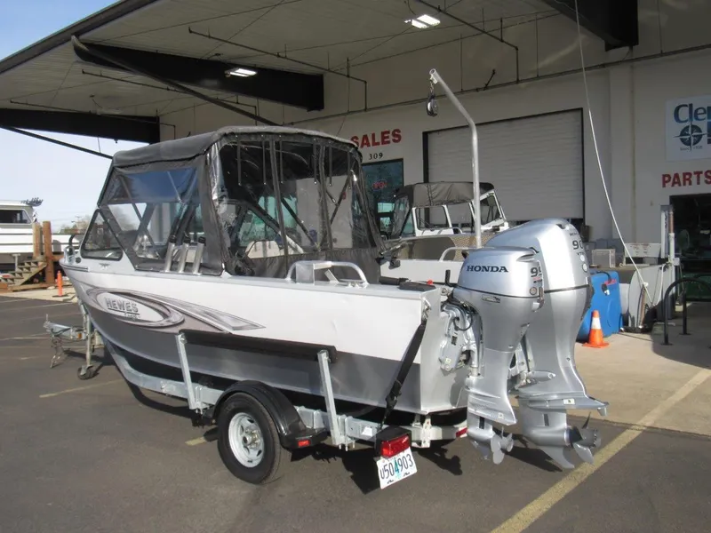Slide: The Image of 2015 Hewescraft 180 Sportsman boat with Honda outboard motor at a dealership. - 3