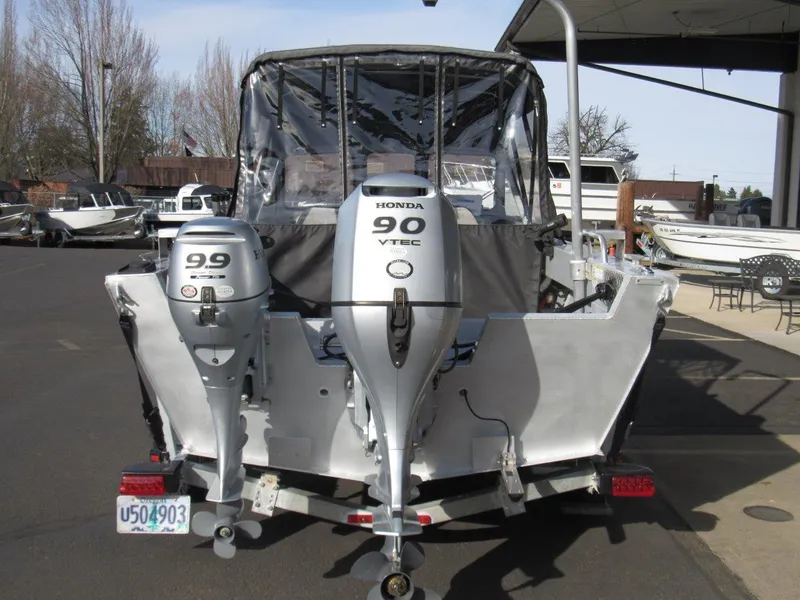 Slide: The Image of 2015 Hewescraft 180 Sportsman boat with dual Honda outboard motors, parked on a trailer. - 4
