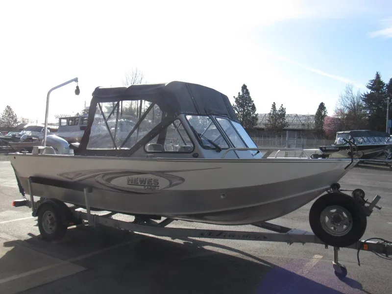 Slide: The Image of 2015 Hewescraft 180 Sportsman boat on trailer, parked outdoors. - 7