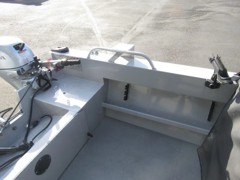 Slide: The Image of 2015 Hewescraft 180 Sportsman boat interior with motor and rod holders. - 9