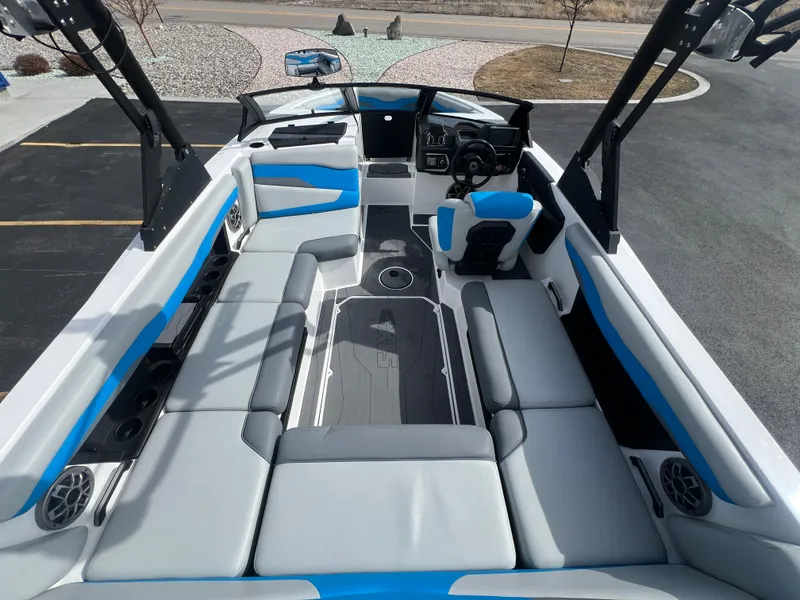 Slide: The Image of 2023 Axis Wake Research T220 boat interior with blue and gray seating, modern design. - 10