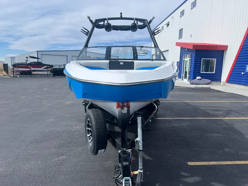 Slide: The Image of 2023 Axis Wake Research T220 boat on trailer in parking lot. - 4