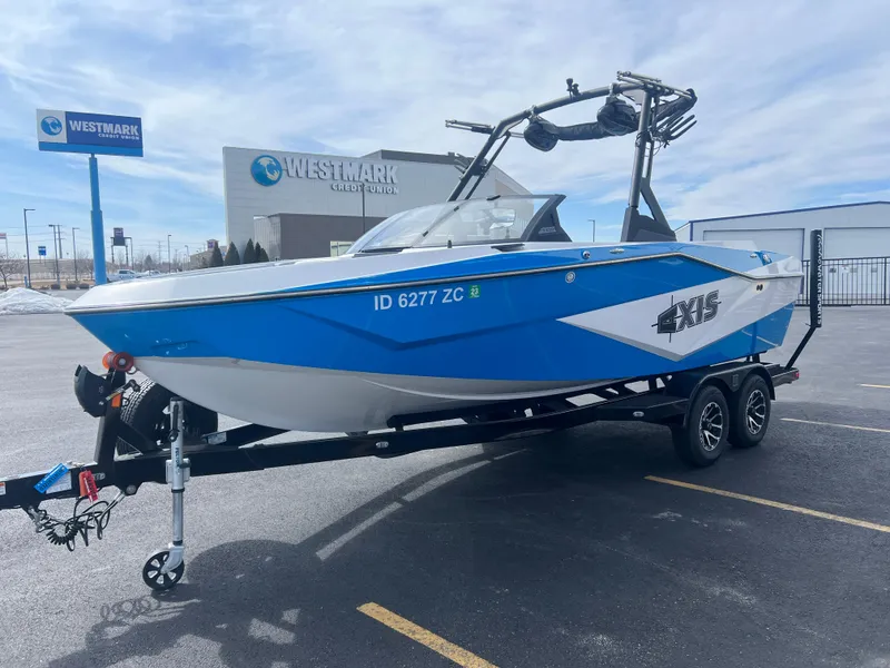 Slide: The Image of 2023 Axis Wake Research T220 boat on trailer near Westmark Credit Union. - 5