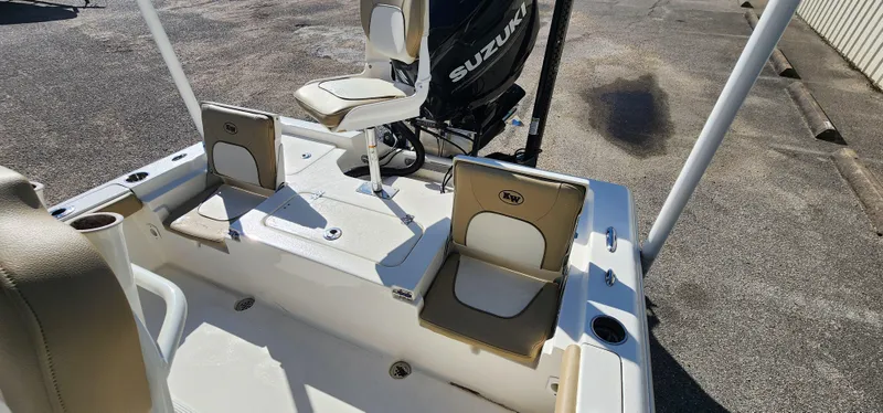 Slide: The Image of 2019 Key West 230BR boat interior with Suzuki engine, featuring seating and storage. - 10