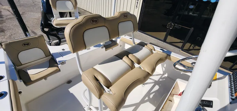 Slide: The Image of 2019 Key West 230BR boat interior with tan and white seating, steering wheel, and console. - 17