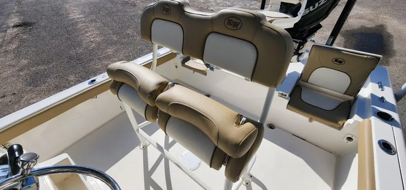 Slide: The Image of 2019 Key West 230BR boat interior with beige seating and steering wheel. - 18