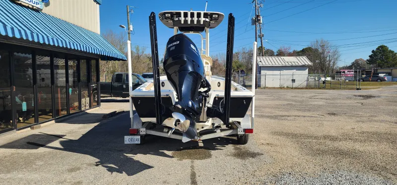 Slide: The Image of 2019 Key West 230BR boat on trailer, parked outside a building under clear blue sky. - 3