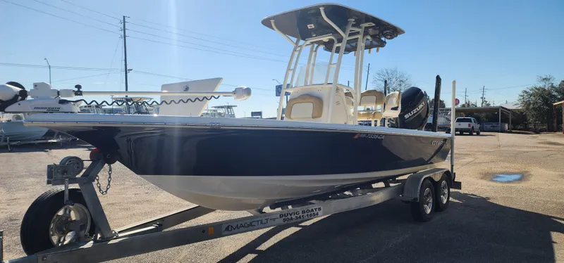 Slide: The Image of 2019 Key West 230BR boat on trailer, parked outdoors under clear sky. - 5