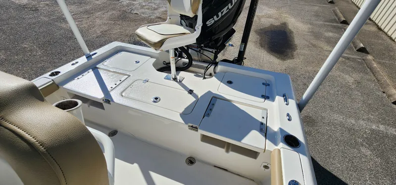 Slide: The Image of 2019 Key West 230BR boat deck with Suzuki motor, featuring storage compartments and seating. - 9
