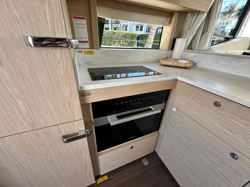 Slide: The Image of 2023 Beneteau Swift Trawler 48 kitchen with modern appliances and sleek cabinetry. - 10