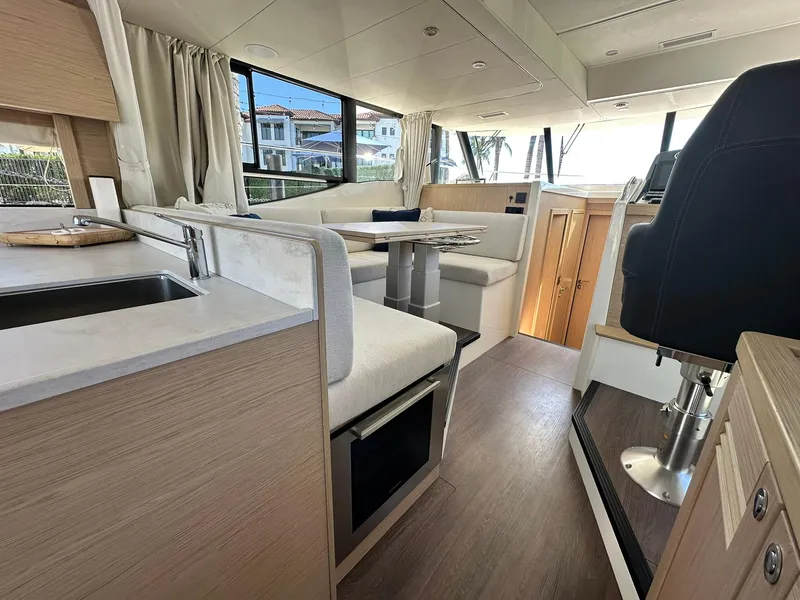 Slide: The Image of Interior of 2023 Beneteau Swift Trawler 48, featuring modern seating and helm station. - 11