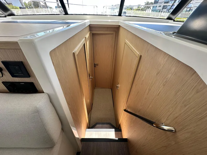 Slide: The Image of Interior of 2023 Beneteau Swift Trawler 48, featuring wooden doors and modern design. - 17
