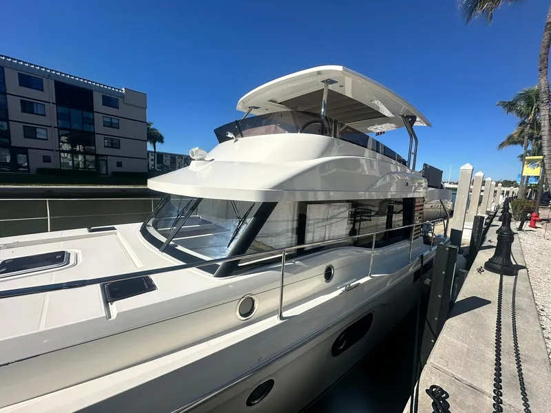 Slide: The Image of 2023 Beneteau Swift Trawler 48 docked, showcasing sleek design and modern features. - 2