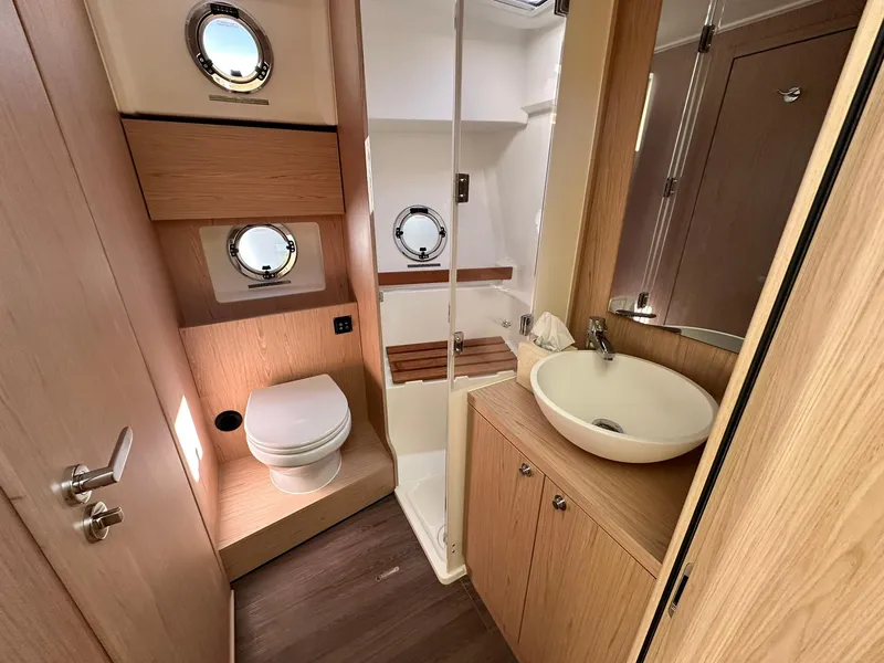 Slide: The Image of 2023 Beneteau Swift Trawler 48 bathroom with modern fixtures and wooden accents. - 20
