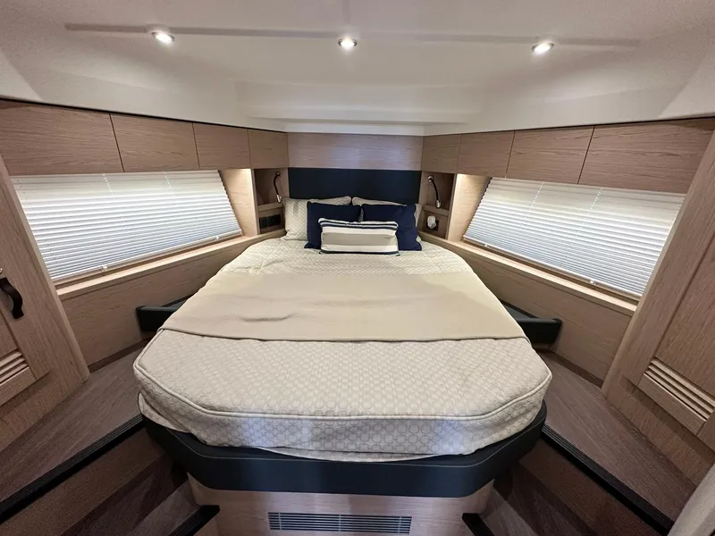 Slide: The Image of Luxurious bedroom interior of 2023 Beneteau Swift Trawler 48 with elegant bedding and ambient lighting. - 21