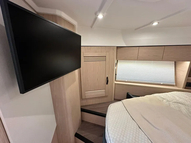 Slide: The Image of 2023 Beneteau Swift Trawler 48 interior cabin with TV and modern furnishings. - 22