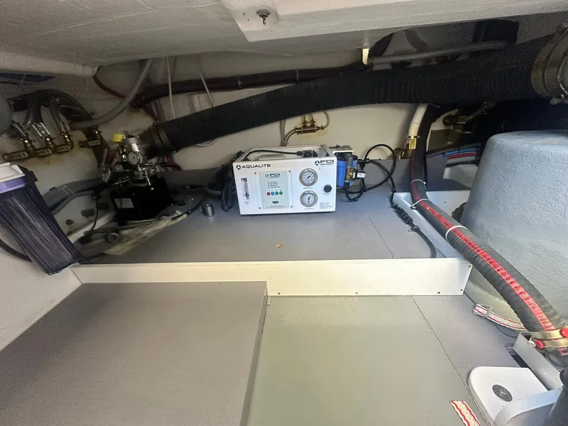 Slide: The Image of 2023 Beneteau Swift Trawler 48 engine room with equipment and wiring. - 36