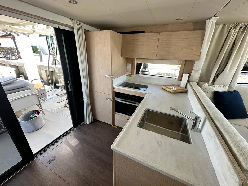 Slide: The Image of 2023 Beneteau Swift Trawler 48 interior kitchen with modern design and sleek finishes. - 6