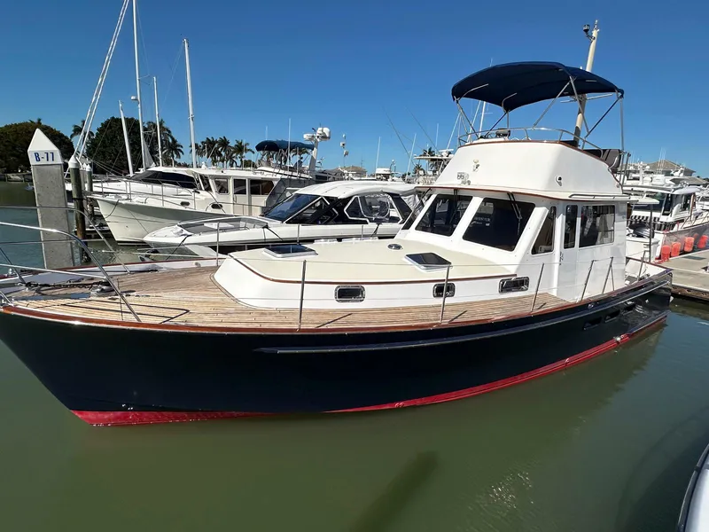 The Image of 2000 Legacy Yachts 40 Sedan docked, featuring classic design and spacious deck. - 0