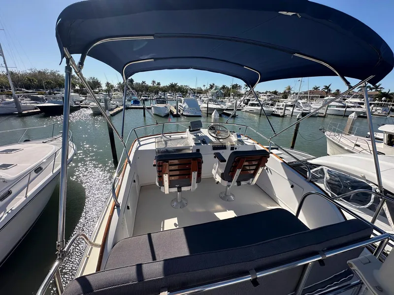 Slide: The Image of Legacy Yachts 40 Sedan 2000 model at marina, featuring spacious deck and seating. - 13