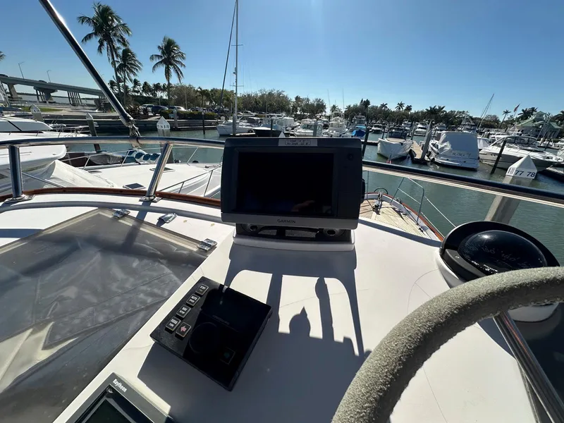 Slide: The Image of Helm of 2000 Legacy Yachts 40 Sedan with navigation equipment, docked in a marina. - 17