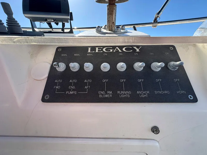 Slide: The Image of Control panel of 2000 Legacy Yachts 40 Sedan with labeled switches. - 18