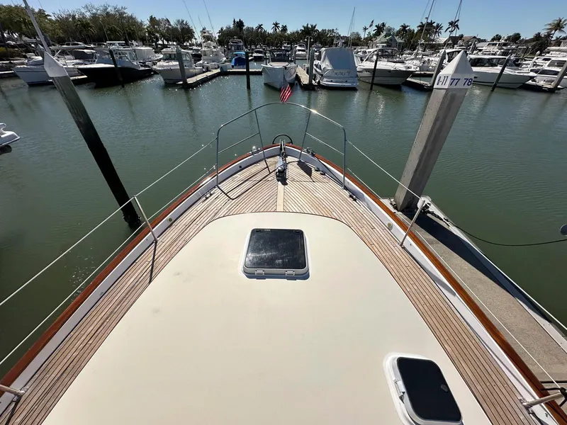 Slide: The Image of Legacy Yachts 40 Sedan 2000 at marina, showcasing bow and deck view. - 21