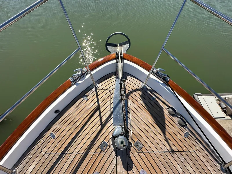 Slide: The Image of Bow of 2000 Legacy Yachts 40 Sedan with wooden deck and anchor chain. - 23