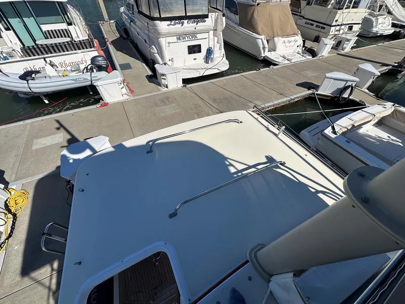 Slide: The Image of Legacy Yachts 40 Sedan 2000 docked at marina with other boats. - 24