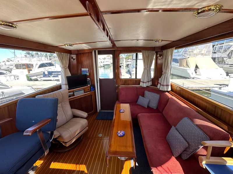 Slide: The Image of Interior of 2000 Legacy Yachts 40 Sedan with plush seating and wooden accents. - 28