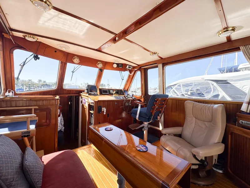 Slide: The Image of Interior of 2000 Legacy Yachts 40 Sedan, featuring wooden finishes and comfortable seating. - 29