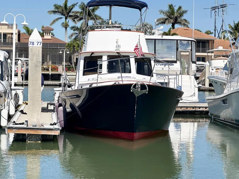 Slide: The Image of Legacy Yachts 40 Sedan 2000 docked at marina with palm trees in background. - 3