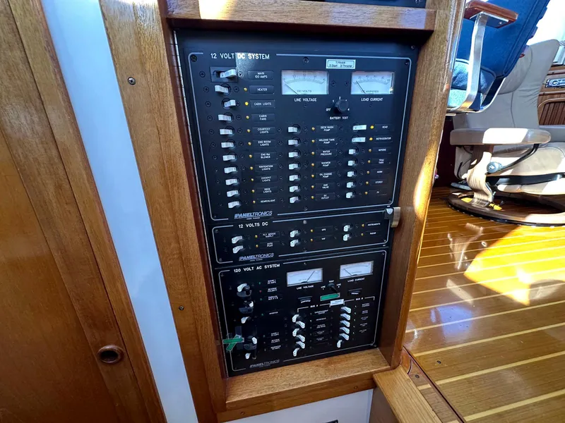 Slide: The Image of Electrical panel on a 2000 Legacy Yachts 40 Sedan, featuring various switches and gauges. - 31