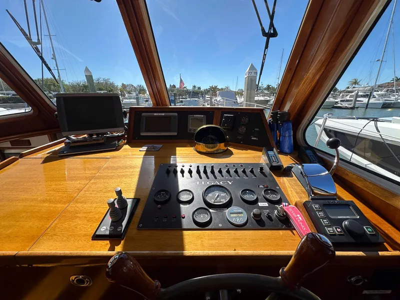 Slide: The Image of Helm of 2000 Legacy Yachts 40 Sedan with navigation instruments and marina view. - 32