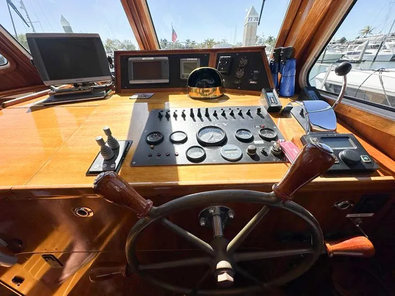 Slide: The Image of Cockpit of 2000 Legacy Yachts 40 Sedan with wooden steering wheel and navigation instruments. - 33