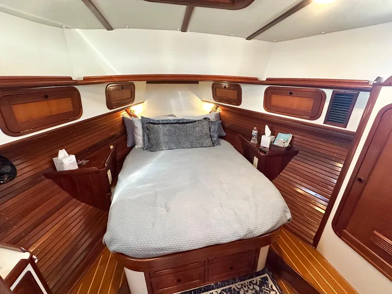 Slide: The Image of Cozy cabin interior of 2000 Legacy Yachts 40 Sedan with wood paneling and comfortable bedding. - 34