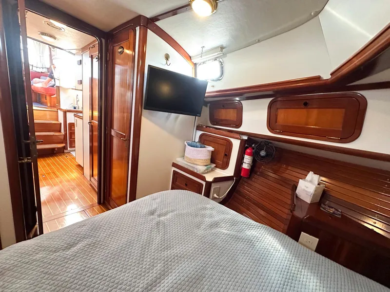 Slide: The Image of Interior of 2000 Legacy Yachts 40 Sedan, featuring wood paneling and a cozy cabin space. - 36