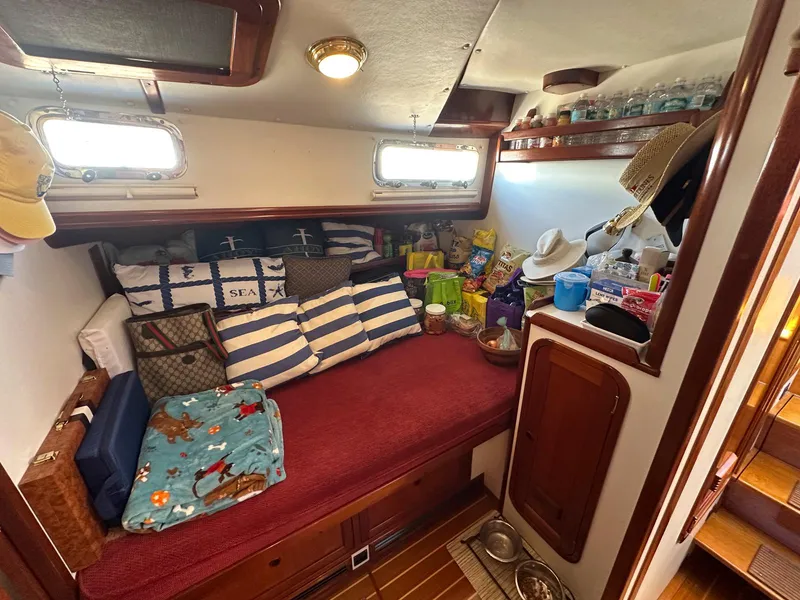 Slide: The Image of Cozy cabin interior of 2000 Legacy Yachts 40 Sedan with nautical decor and storage. - 37